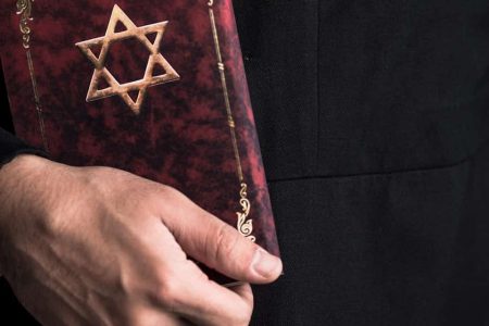 panoramic shot of young jewish man holding tanakh